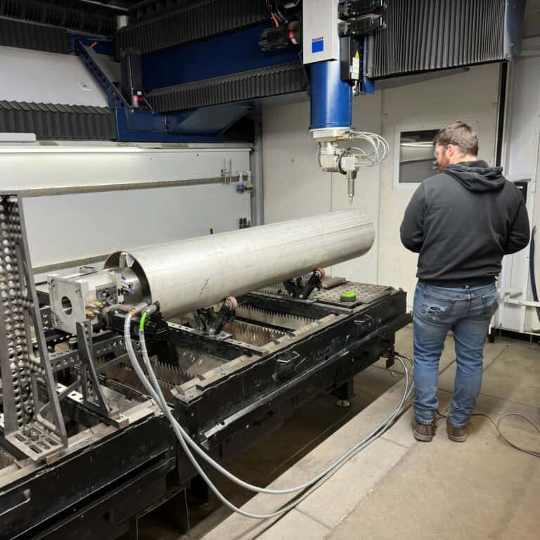 Prima Optimo 5-axis laser at Northern Manufacturing cutting a complex bevel on a formed stainless steel part, showcasing tight tolerance 3D cutting capability.