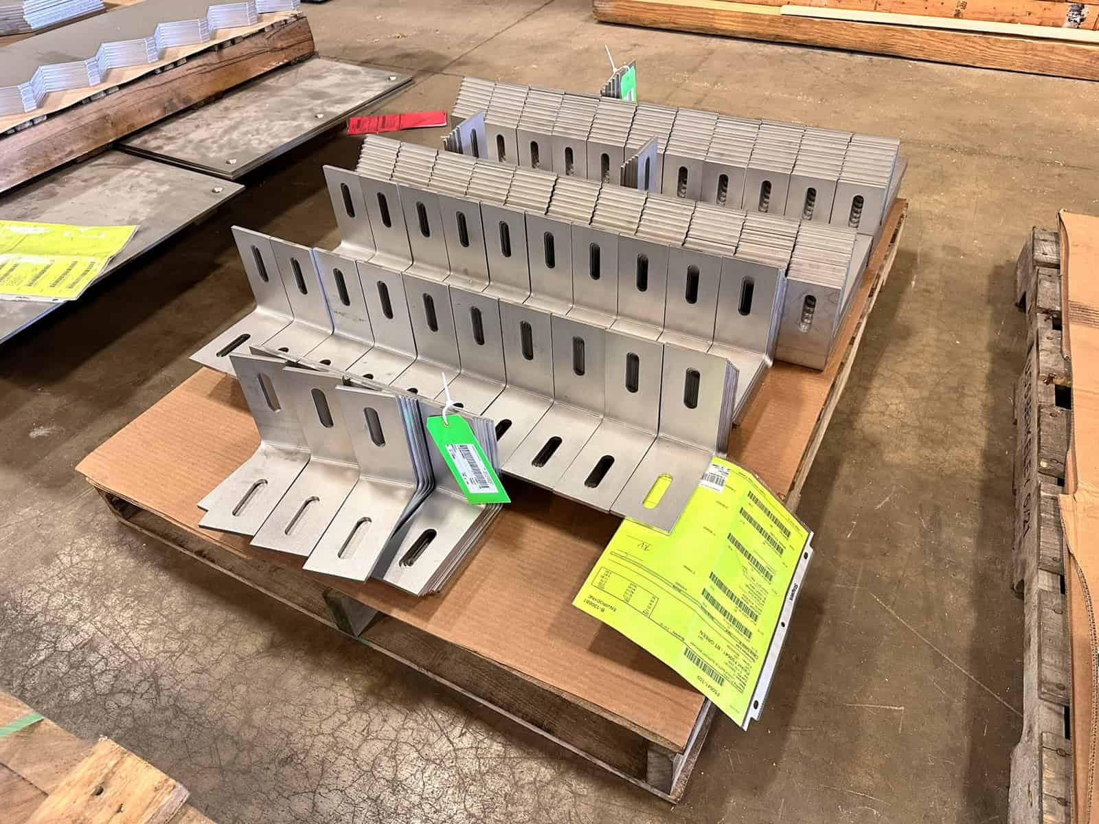 5-Axis Laser Cutting Hero Image stainless steel laser cut brackets on a skid, ready for shipment