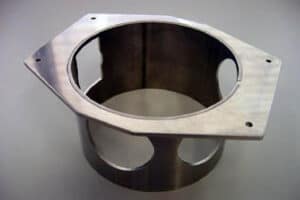 Close-up of a high-quality precision-cut stainless steel tube component demonstrating intricate laser-cut features such as rounded openings and a flat base, showcasing expert tube laser cutting services.