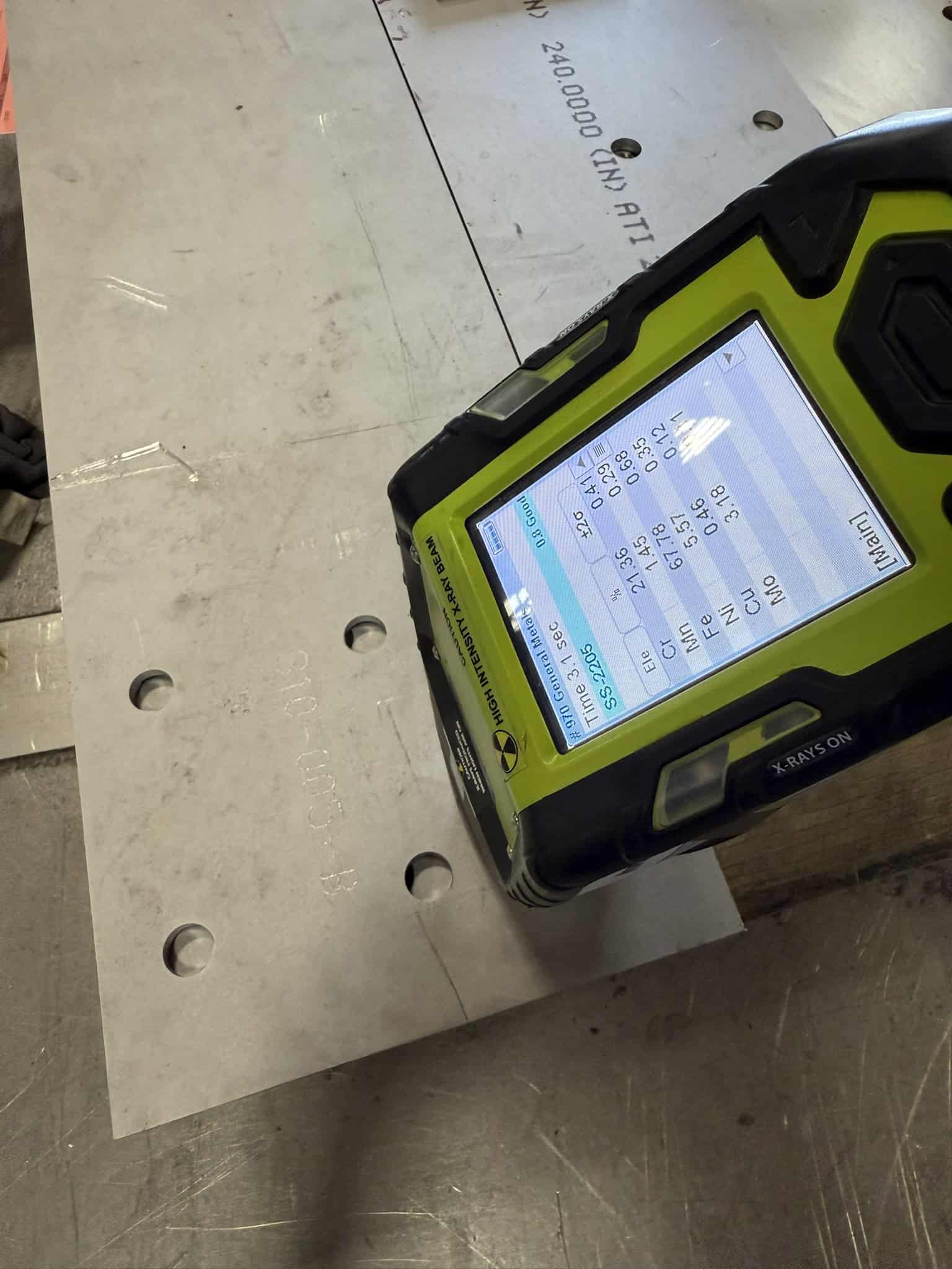 Niton Gun providing Positive Material Identification results for stainless steel parts.