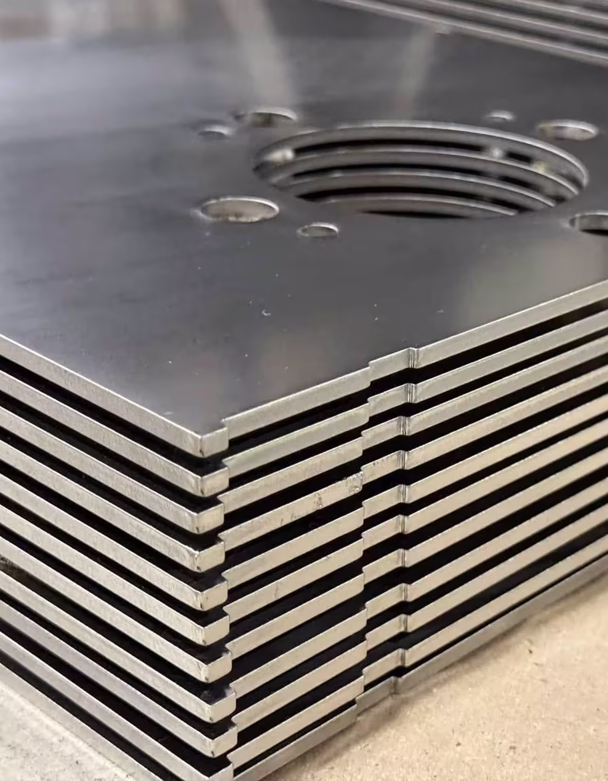 laser cut stainless steel parts stacked after deburring